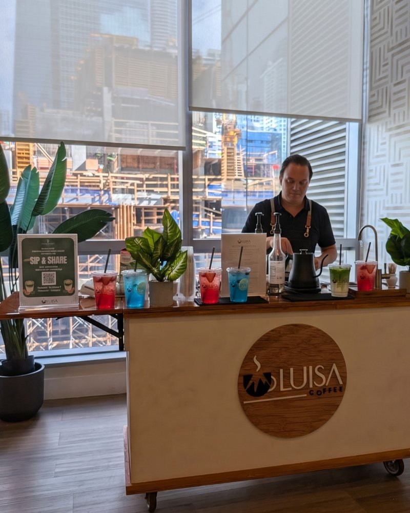 A barista serving flavored refreshers at a branded Miami Refresher Cart activation